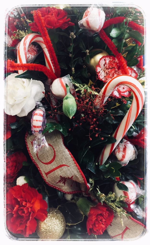 Festive bouquet with candy canes and flowers.