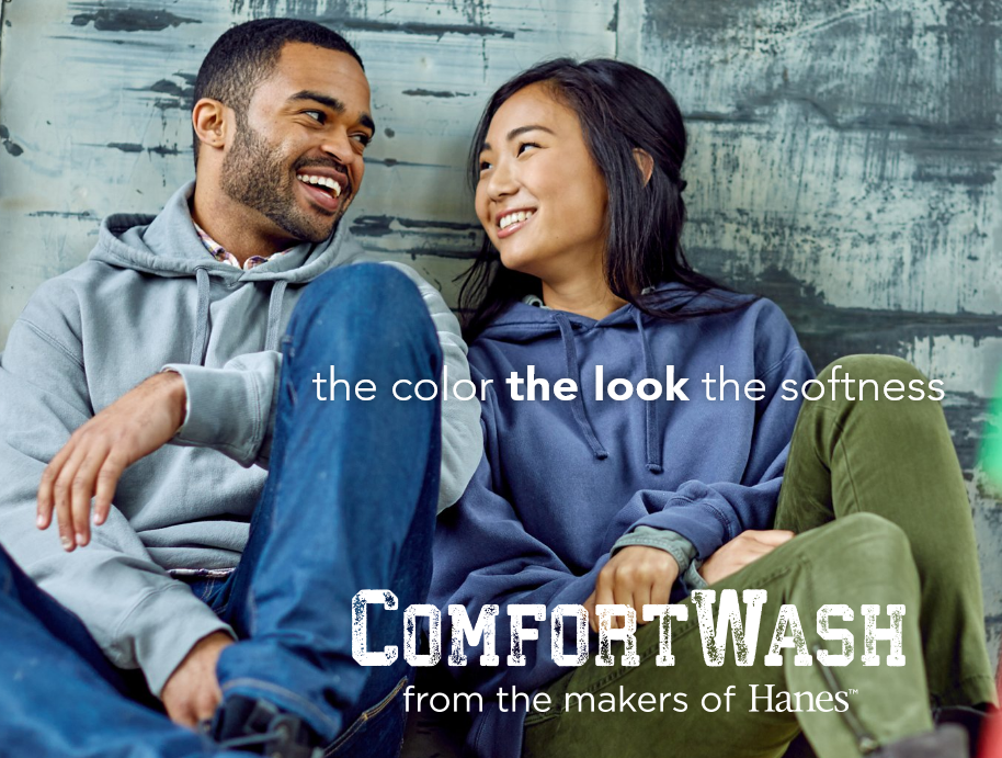 Couple smiling in ComfortWash hoodies advertisement.