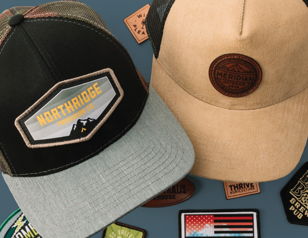Two baseball caps with embroidered logos.
