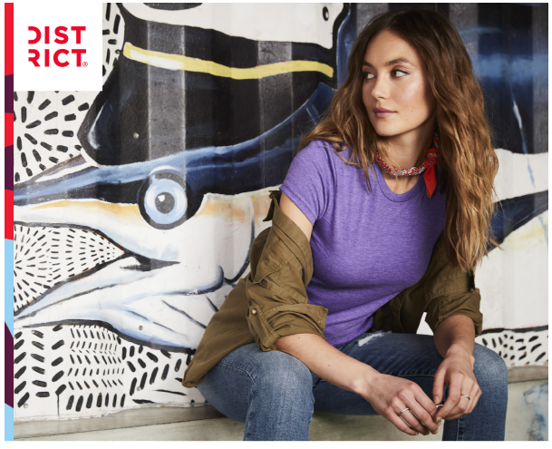 Woman sitting in front of fish mural.