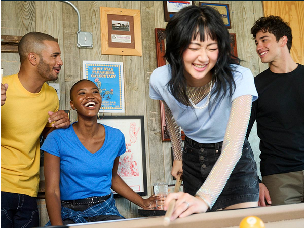 Friends playing pool and laughing together.